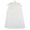 Baby’s Dress in piqué fabric and pink bows.