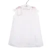 Short baby dress in white piqué fabric and pink bows